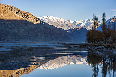 The crystal clear Shyok River creates a mirror image in the Khapalu valley near Skardu, Gilgit-Baltistan, Pakistan, Asia