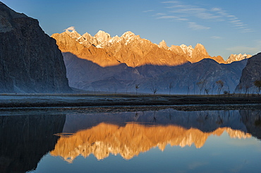 The crystal clear Shyok River creates a mirror image of sunrise on Karakoram peaks beyond the Khapalu valley near Skardu, Gilgit-Baltistan, Pakistan, Asia