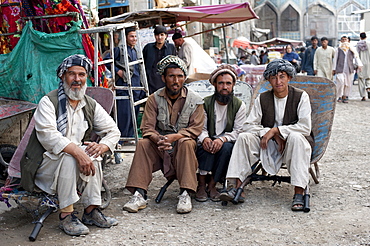 Taking a load off, a quick time out for these hard working Afghans in a bazaar in Kabul, Afghanistan, Asia