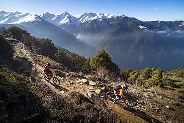 Mountain biking along a Enduro style single track trail in the Nepal Himalayas near the Langtang region, Nepal, Asia