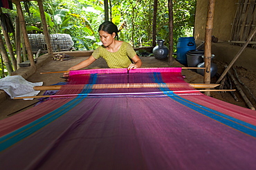 A woman weaves traditional fabric using a hand loom, Chittagong Hill Tracts, Bangladesh, Asia