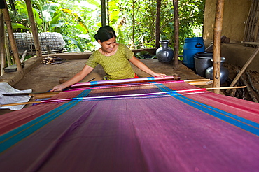 A woman weaves traditional fabric using a hand loom, Chittagong Hill Tracts, Bangladesh, Asia