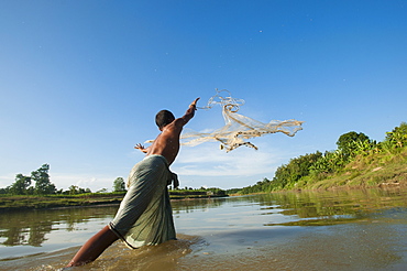 A man casts his net into the river in the Kharacharri district of the Chittagong Hill Tracts. Bangladesh, Asia