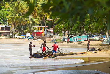 Fisherman organise their nets in Castara bay in Tobago, Trinidad and Tobago, West Indies, Caribbean, Central America