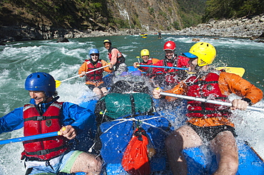 Rafters get splashed as they go through some big rapids on the Karnali River in Nepal, Asia