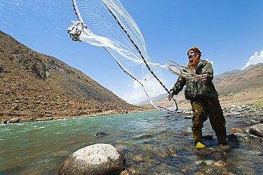 A man from the Panjshir Valley fishes with a throw-net, Afghanistan, Asia