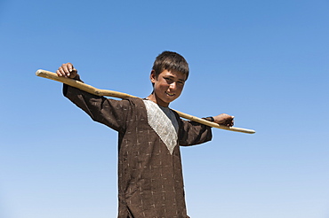 Shepherd boy takes a break in the hot sun in Bamiyan Province, Afghanistan, Asia