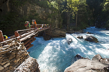 Hikers crossing a wooden bridge between Chhepka and Amchi Hospital in Dolpa, a remote region of Nepal, Himalayas, Nepal, Asia