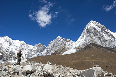 A trekker in the Everest region on the way up to Everest Base Camp, a view of Pumori in the distance, Khumbu Region, Himalayas, Nepal, Asia