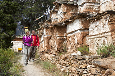 Trekking past a line of Tibetan chortens near Phoksundo lake in Dolpa, a remote region of Nepal, Asia