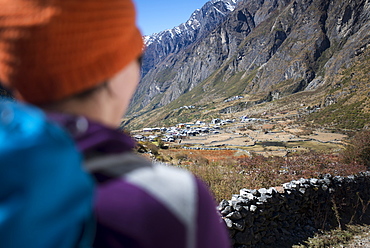 A woman trekking in the Langtang valley rests near a chorten, Langtang Region, Himalayas, Nepal, Asia