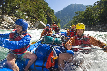 Rafters get splashed as they go through some big rapids on the Karnali River, west Nepal, Asia