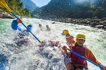 Rafters get splashed as they go through some big rapids on the Karnali River, west Nepal, Asia