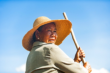 A farmer with a hand tool in Yunnan Province, China, Asia