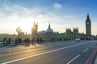 Pedestrians on Westminster Bridge with Houses of Parliament and Big Ben at sunset, London, England, United Kingdom, Europe