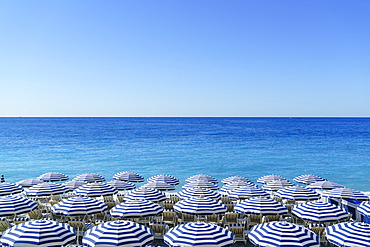 Blue and white beach parasols, Nice, Cote d'Azur, Alpes-Maritimes, Provence, French Riviera, France, Mediterranean, Europe