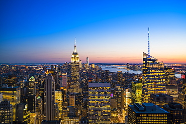 Manhattan skyline and Empire State Building at dusk, New York City, United States of America, North America