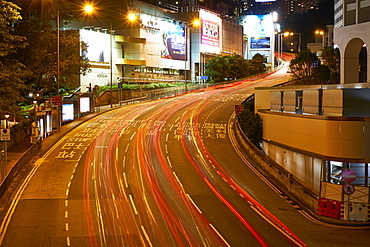 Car light trails on a busy road in Central, Hong Kong Island by night, Hong Kong, China, Asia