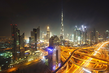 Dubai skyline and Sheikh Zayed Road Interchange by night, Dubai, United Arab Emirates, Middle East