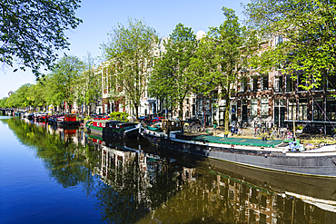 Old gabled buildings reflecting in a canal, Amsterdam, North Holland, The Netherlands, Europe