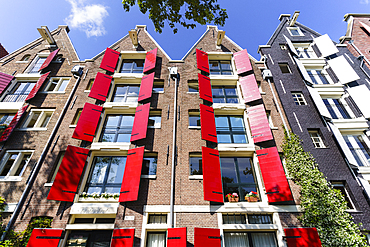 Red shutters on traditional Dutch style building, Amsterdam, North Holland, The Netherlands, Europe