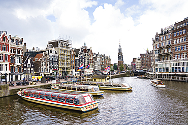 Tourist boats on Amstel River near Muntplein and Rokin, Amsterdam, North Holland, The Netherlands, Europe