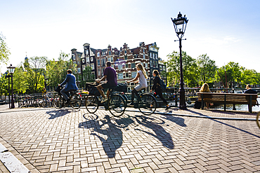 Cyclists on a bridge over Brouwersgracht, Amsterdam, North Holland, The Netherlands, Europe