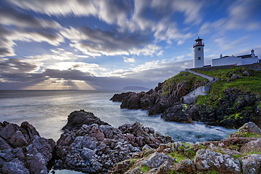 Sunrise over the Atlantic Ocean and Fanad Head Lighthouse in County Donegal, Ulster, Republic of Ireland, Europe