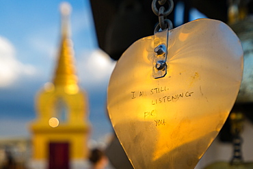 Golden prayer flag etching with Buddhist gold stupa in background, Bangkok, Thailand, Southeast Asia, Asia