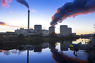 Industrial chimney smoke and smoke from scrap yard tyre fire, River Clyde, Glasgow, Scotland, United Kingdom, Europe