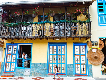 Housefront with man and girl, Filandia, Coffee Region, Colombia, South America