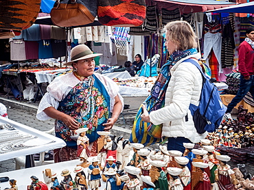 Tourist shopping at market, Plaza de los Ponchos, Otavalo, Ecuador, South America