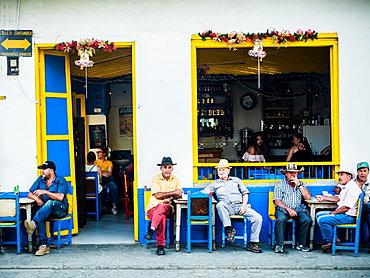 Men sit outside a bar, Jardin, Antioquia, Colombia, South America