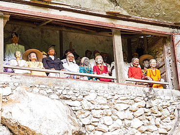 A gallery of tao-taos (statues of ancestors) at a cliff gravesite, Tana Toraja, Sulawesi, Indonesia, Southeast Asia, Asia