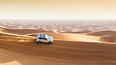 Offroad vehicle on sand dunes near Dubai, United Arab Emirates, Middle East