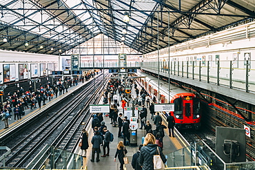 Commuters at Earl's Court Tube station on the District and Circle line platforms, Earls Court, London, England, United Kingdom, Europe