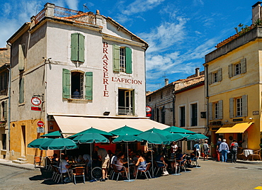 Tourists sit at an outdoor terrace in the historic centre of Arles, Bouches-du Rhone, Provence, France, Europe