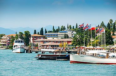 Busy marina and ferry terminal at Sirmione, Lake Garda, Lombardy, Italian Lakes, Italy, Europe