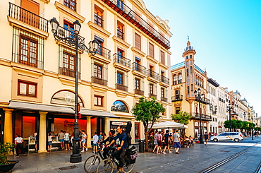 Pedestrians and cyclists on Avenida de la Constitucion in the historic centre of Seville, Andalusia, Spain, Europe