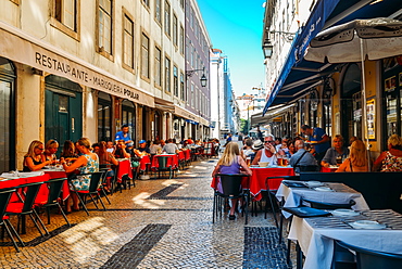 Busy outdoor terrace Portuguese restaurants at Rua da Prata catering to tourists, Lisbon, Portugal, Europe