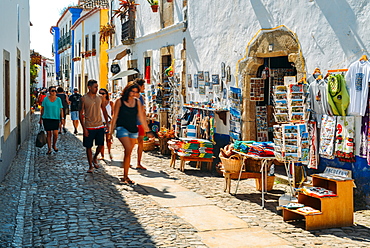 Tourists and shops in the typical alleys of the ancient fortified village of Obidos, Oeste Leiria District, Portugal, Europe