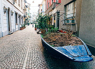 A boat filled with plants on a street in Stresa, Piedmont, Italy, Europe