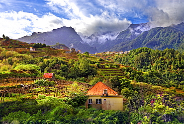 Elevated view of village and tree covered hills and mountains at Lameiros, near Sao Vicente, Madeira, Portugal, Atlantic, Europe