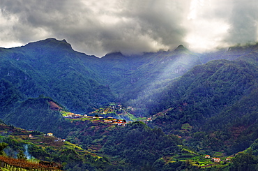 Elevated view of a remote village and tree covered hills and mountains near Sao Vicente, Madeira, Portugal, Atlantic, Europe