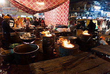 Flaming dishes on the streets as men prepare food for the Chandni Chowk Gudurwara, Delhi, India, Asia