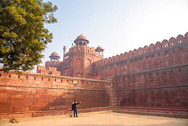 A couple take a selfie while a dog sunbathes at The Red Fort, UNESCO World Heritage Site, Old Delhi, India, Asia