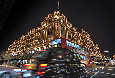 A London taxi and a London bus drive past Harrods, London, England, United Kingdom, Europe