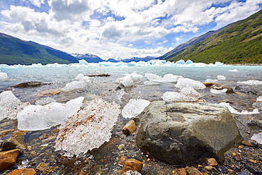 Blocks of ice float in one of the affluents of Lago Argentino, next to Perito Moreno Glacier, and wash ashore by the rocks, Los Glaciares National Park, UNESCO World Heritage Site, Patagonia, Argentina, South America