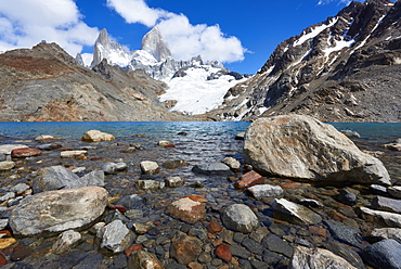 Stones seen through the water of Lago de los Tres featuring Monte Fitz Roy in the background. Monte Fitz Roy, Patagonia, Argentina, South America