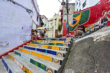 Tourists sitting on Selaron Steps, 215 decorated steps the work of artist Jorge Selaron, Rio de Janeiro, Brazil, South America